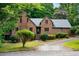 Charming brick home featuring a well-maintained lawn and complemented by mature trees, offering a welcoming curb appeal at 9055 Green Valley Ct, Douglasville, GA 30134