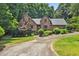 Brick house with a well-manicured lawn and lush landscaping, creating a welcoming and picturesque curb appeal at 9055 Green Valley Ct, Douglasville, GA 30134