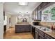 Open kitchen featuring granite counters, stainless appliances, tile backsplash, and wood floors at 9055 Green Valley Ct, Douglasville, GA 30134