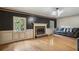 Spacious living room with hardwood floors, fireplace, and modern lighting, creating a cozy and inviting atmosphere at 9055 Green Valley Ct, Douglasville, GA 30134