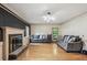 Spacious living room with hardwood floors, fireplace, and modern lighting, creating a cozy and inviting atmosphere at 9055 Green Valley Ct, Douglasville, GA 30134