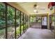 Spacious screened-in porch offers serene views of the wooded backyard at 9055 Green Valley Ct, Douglasville, GA 30134