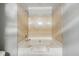 Bathroom features a tub with shower head and light tan tile walls at 9055 Green Valley Ct, Douglasville, GA 30134