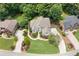Aerial view of a home featuring a lush lawn, mature trees, and circular driveway at 1345 Benbrooke Nw Ln, Acworth, GA 30101