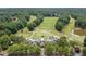 Aerial view of a golf course and surrounding houses nestled among lush green trees at 1345 Benbrooke Nw Ln, Acworth, GA 30101