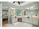 Light-filled bathroom with dual sinks, vanity, large mirrors, and a view to the connected bedroom at 1345 Benbrooke Nw Ln, Acworth, GA 30101