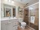 The well-lit bathroom features a glass shower, white vanity, and tile flooring at 1345 Benbrooke Nw Ln, Acworth, GA 30101