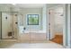 Spa-like bathroom with a glass-enclosed shower, a soaking tub, and views of a spacious walk-in closet at 1345 Benbrooke Nw Ln, Acworth, GA 30101