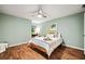 The sunny bedroom boasts wood floors, a ceiling fan, and plenty of natural light at 1345 Benbrooke Nw Ln, Acworth, GA 30101