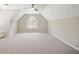 This airy bonus room features neutral paint colors, plush carpet, an arched window, and plantation shutters at 1345 Benbrooke Nw Ln, Acworth, GA 30101