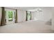 This airy bonus room features neutral paint colors, plush carpet, and french doors with access to the outdoors at 1345 Benbrooke Nw Ln, Acworth, GA 30101