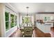 Sunlit dining area features hardwood floors, a chandelier, and large windows providing an abundance of natural light at 1345 Benbrooke Nw Ln, Acworth, GA 30101