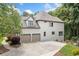 Exterior view of home featuring a three-car garage and well-maintained landscaping at 1345 Benbrooke Nw Ln, Acworth, GA 30101