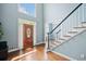 Welcoming foyer with hardwood floors, staircase, and light-filled entryway at 1345 Benbrooke Nw Ln, Acworth, GA 30101