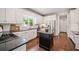 Modern kitchen features stainless steel appliances, granite countertops, a dark island, and ample cabinet space at 1345 Benbrooke Nw Ln, Acworth, GA 30101