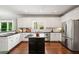 Well-lit kitchen with granite counters, stainless steel refrigerator, and large island at 1345 Benbrooke Nw Ln, Acworth, GA 30101