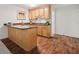 This cozy kitchenette features granite countertops, wood cabinets, and hardwood floors at 1345 Benbrooke Nw Ln, Acworth, GA 30101