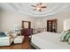 Bright primary bedroom featuring hardwood floors, tray ceilings, a seating area and large closet at 1345 Benbrooke Nw Ln, Acworth, GA 30101