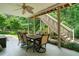 Covered patio features a large outdoor dining area and staircase leading to the upper level at 1345 Benbrooke Nw Ln, Acworth, GA 30101