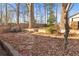 Private fenced backyard with mature trees and a stone paver pathway provides a natural aesthetic at 1015 Deckner Sw Ave, Atlanta, GA 30310
