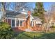 Charming brick home featuring a well-maintained lawn, beautiful landscaping, and a welcoming front entrance at 1015 Deckner Sw Ave, Atlanta, GA 30310