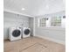 Bright and functional laundry room features modern appliances and shelving for storage solutions at 1015 Deckner Sw Ave, Atlanta, GA 30310