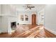 Sun-drenched living room featuring hardwood floors, a fireplace, and a unique front door at 1015 Deckner Sw Ave, Atlanta, GA 30310