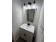 Modern bathroom featuring a new vanity with updated light fixture and mirror at 10591 Flat Shoals Rd Rd, Covington, GA 30016