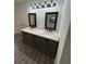 Beautiful bathroom featuring a double sink vanity with modern fixtures and decorative mirrors at 10591 Flat Shoals Rd Rd, Covington, GA 30016