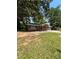Quaint single story home with a green metal roof and a cozy front yard at 10591 Flat Shoals Rd Rd, Covington, GA 30016