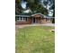 Charming single story home with a green metal roof and inviting front porch at 10591 Flat Shoals Rd Rd, Covington, GA 30016
