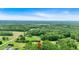 Aerial view showcases the property's expansive greenery and lush surroundings at 146 Henderson Farm Ln, Canton, GA 30115