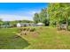Expansive backyard with manicured lawn, fire pit, swimming pool, outbuildings, and mature trees for outdoor enjoyment at 146 Henderson Farm Ln, Canton, GA 30115