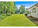 Lush green backyard with mature trees and a glimpse of the swimming pool at 146 Henderson Farm Ln, Canton, GA 30115