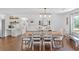 Elegant dining room with wood floors, white walls, and contemporary lighting fixture over a wooden table at 146 Henderson Farm Ln, Canton, GA 30115