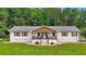 Charming one-story home with a welcoming front porch and a well-manicured lawn and beautiful landscape at 146 Henderson Farm Ln, Canton, GA 30115