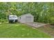 The garage is located on a large lot surrounded by plenty of trees, a concrete driveway, and grass at 146 Henderson Farm Ln, Canton, GA 30115