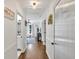 Bright hallway with hardwood floors, white wainscoting, and decorative lighting at 146 Henderson Farm Ln, Canton, GA 30115