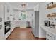 Modern white kitchen featuring stainless steel appliances and ample cabinet space at 146 Henderson Farm Ln, Canton, GA 30115