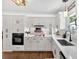 Elegant kitchen with white cabinetry, stone countertops, and dark hardwood flooring at 146 Henderson Farm Ln, Canton, GA 30115