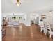 Open-concept living room with wood floors, leading to a dining area and a modern kitchen at 146 Henderson Farm Ln, Canton, GA 30115
