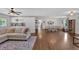 Open-concept living area with hardwood flooring and views into the dining and kitchen at 146 Henderson Farm Ln, Canton, GA 30115