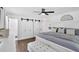 Bright main bedroom features dark wood floors, ceiling fan, and sliding closet doors at 146 Henderson Farm Ln, Canton, GA 30115