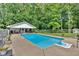 Backyard pool area surrounded by lush greenery, perfect for relaxation and recreation at 146 Henderson Farm Ln, Canton, GA 30115