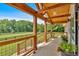 Covered front porch featuring wood beams, landscaping, and views of the home's expansive front yard at 146 Henderson Farm Ln, Canton, GA 30115