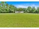 Picturesque view of a well-maintained home surrounded by a lush green lawn and a classic wooden fence at 146 Henderson Farm Ln, Canton, GA 30115