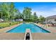 Large backyard pool has a diving board, ladder, and plenty of space for swimming and relaxation on sunny days at 146 Henderson Farm Ln, Canton, GA 30115