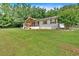 Well-kept front yard leading to a lovely home with an inviting front porch and surrounding green spaces at 146 Henderson Farm Ln, Canton, GA 30115