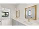 Bathroom with dual sinks, gold hardware, and decorative mirrors across from bedroom view at 3785 Lower Roswell Rd, Marietta, GA 30068