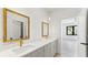 Bathroom with dual sinks, gold hardware, and decorative mirrors across from bedroom view at 3785 Lower Roswell Rd, Marietta, GA 30068